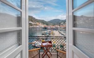 a view from a window of a harbor at Douskos Exclusive Property in Hydra