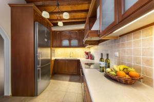 a kitchen with a basket of fruit on the counter at Douskos Exclusive Property in Hydra +11 photos