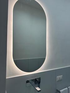 a large mirror in a bathroom with a sink at Ziro Suite Luxury House in Amalfi