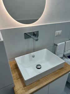 a bathroom with a white sink and a mirror at Ziro Suite Luxury House in Amalfi +34 photos