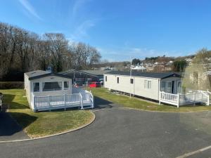 a mobile home is parked next to a road at Whitecliff Bay Holiday Park - Most popular location near Pools, Clubs and Beach in Bembridge