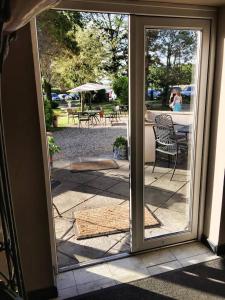 an open door to a patio with a table and chairs at Meifod House in Caernarfon