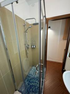 a shower with a glass door in a bathroom at Mondello suite apartment in Mondello