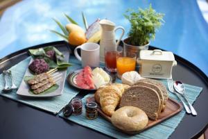 a tray of breakfast foods on a table at Private Pool Villa 88 Nimman Chiangmai in Chiang Mai