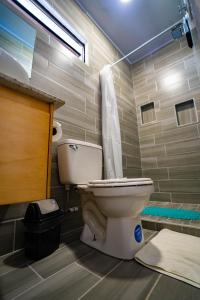 a bathroom with a toilet and a shower at Nomada Monteverde in Monteverde Costa Rica