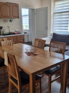 a kitchen with a wooden table and chairs with a bowl on it at Ferienwohnung am Kanuverleih in Oderberg +1 photo