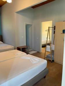 a room with two beds and a ladder in it at Chalet Ambel in Dhërmi