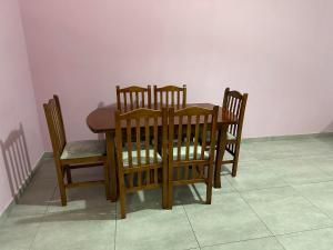 a dining room table and four chairs and a table and a table and chairsktop at Albania,Tirana,Kamëz in Kamëz +2 photos