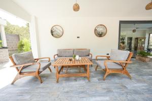 a patio with two chairs and a wooden table at ADA BOUTİQUE HOTEL in Marmaris