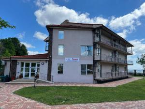 a building with a sign on the side of it at IOANA - camere de inchiriat in Mangalia