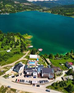 an aerial view of a resort with a lake at Hotel Roser House Boutique - pe malul lacului Colibita in Colibiţa