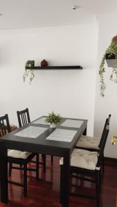 a dining room table with chairs and plants on it at Apartment Aire del Mar in Liencres