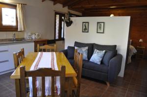 a living room with a table and a couch at La Aljaba in El Bolsón