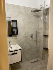 a bathroom with a shower and a sink at AJ Apartments in Orikum +62 photos