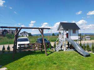 a playground with a slide and a play house at Widokowa Polana in Szaflary