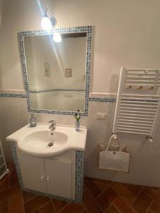 a bathroom with a sink and a mirror at Vannucci 130 in Città della Pieve +17 photos