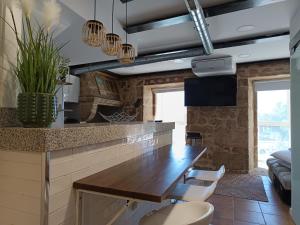 a kitchen with a wooden table in a room at La Guinda Real- Centro histórico in Vigo