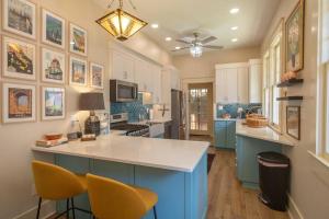 a kitchen with blue cabinets and a white counter top at Midtown Central Gardens Bungalow in Memphis