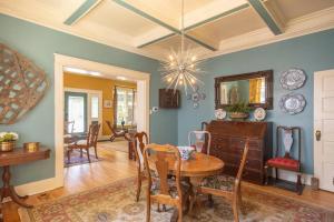 a dining room with a table and a mirror at Midtown Central Gardens Bungalow in Memphis +11 photos