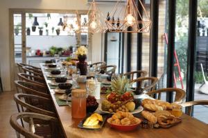 a long table with food on top of it at Private Pool Villa 88 Nimman Chiangmai in Chiang Mai +45 photos
