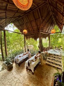 a group of people laying in beds in a pavilion at Eco Hostal Yuluka in El Zaino
