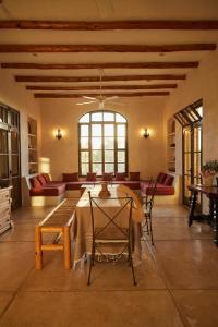 a living room with a table and chairs and a couch at Casa Piedra - Close To The Beach! in Todos Santos