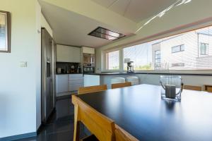 a kitchen with a table with a glass on it at Päikeseline Apartment WITH SAUNA in Kuressaare