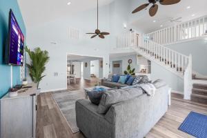a living room with a couch and a tv at Kokomo in Myrtle Beach
