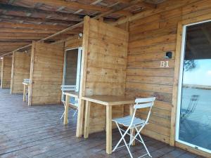 a wooden cabin with a table and chairs on a deck at COMPORTA SIDE - Lake in Setúbal