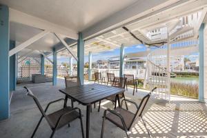 a patio with a table and chairs on a deck at Kokomo in Myrtle Beach