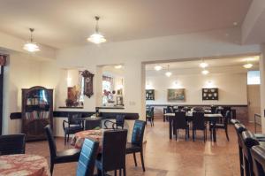 a restaurant with tables and chairs in a room at Hotel Na Skalkách in Nový Jičín