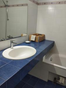 a bathroom with a white sink and a blue counter at V.K.Seaside Villa in Volos +72 photos