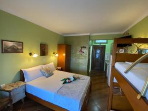 a bedroom with two beds and a bathroom at Villa Doxa in Sarti