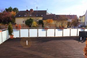 a wooden deck with a view of the water at Hotel am Hirschgarten in Filderstadt