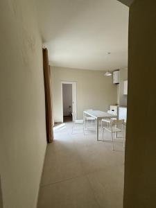 a dining room and kitchen with a table and chairs at La Corte degli Scolopi in Palma di Montechiaro +4 photos