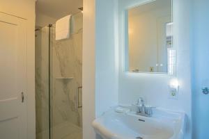 a white bathroom with a sink and a shower at Yankee Clipper Inn in Rockport +32 photos