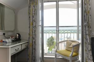a kitchen with a chair in front of a window at The Lough & Quay Accommodation Seaside Property in Warrenpoint