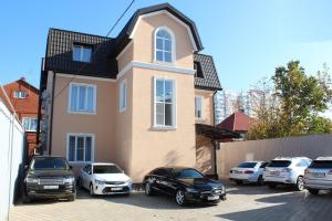 a group of cars parked in front of a house at Chocolatier Hotel in Krasnodar
