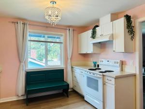 a kitchen with a white stove top oven next to a window at Audrey in Salem