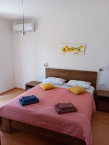 a bedroom with a large bed with two towels on it at Apartman Suzy in Pula