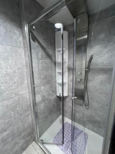 a shower with a glass door in a bathroom at I 7 MARI home in Salerno +32 photos