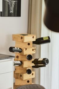 a bunch of wine bottles in a wooden wine rack at Stilvolles, lichtdurchflutetes Luxus-Appartement in der Residenz Silvretta - Inklusive Silvretta Card Premium in See