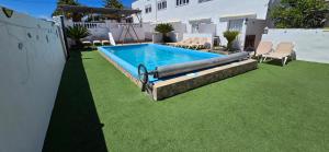 a swimming pool in a yard with green grass at Quiet area - Terrace - Pool - Parking - Aduls only in Tías
