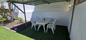 a white table and chairs on a patio at Direktly at our Swimming pool - Relax - Aduls only in Tías +17 photos