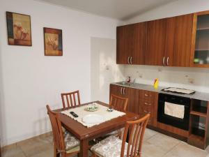 a kitchen with a table and chairs and a kitchen with a stove at Nuccia'S House in Reggio di Calabria