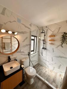 a bathroom with a toilet and a sink and a mirror at Casa da Ribeira in Vila do Bispo +28 photos