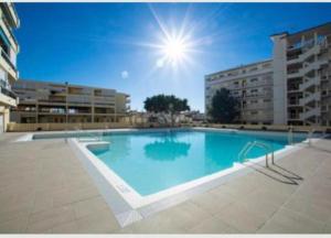 a large swimming pool in front of a building at Carihuela Beach in Torremolinos