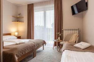a hotel room with two beds and a window at Sykowny Biały Dunajec in Zakopane +52 photos