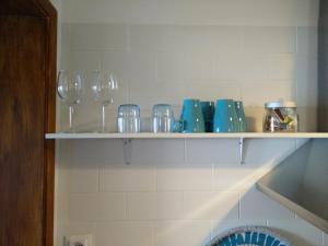 a shelf with glasses and other items on it at Xavier - Alfama Apartment River View in Lisbon