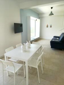 アルカモ・マリーナにあるCastellammare Rivieraのリビングルームの白いテーブルと椅子
